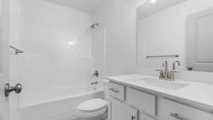 Full bathroom with vanity, shower / bathing tub combination, and toilet