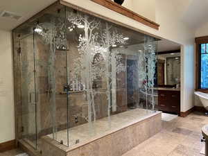 Bathroom featuring vanity, plus walk in shower, tile patterned flooring, and lofted ceiling