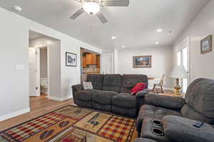 Living room featuring ceiling fan and light wood-type flooring