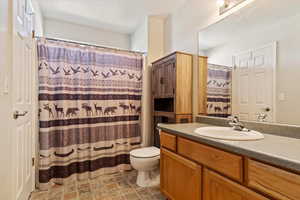 Bathroom with vanity, tile patterned flooring, and toilet