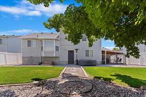 Back of property with a patio area and an outdoor fire pit