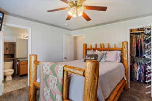 Bedroom with a closet, ceiling fan, crown molding, carpet floors, and ensuite bathroom