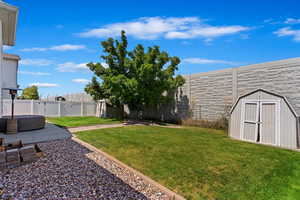 View of yard with a storage shed and a patio area