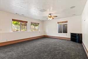 Interior space featuring carpet floors and ceiling fan