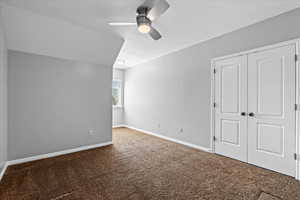 Unfurnished bedroom with a closet, carpet flooring, and ceiling fan