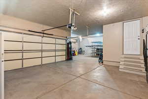 Garage featuring a garage door opener