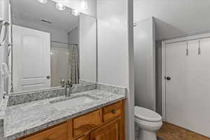 Bathroom with tile patterned floors, toilet, and vanity