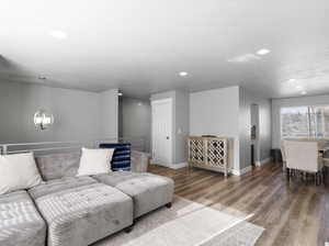 Living room with a notable chandelier and hardwood / wood-style floors