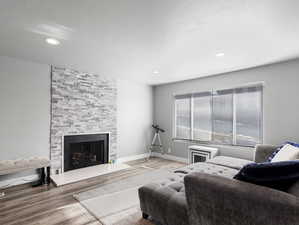 Living room with hardwood / wood-style flooring and a fireplace