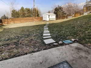 View of yard with a storage unit