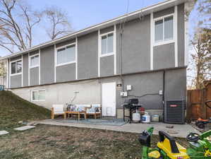 Rear view of house with a patio and central air condition unit