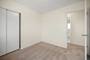 Unfurnished bedroom with carpet and a closet