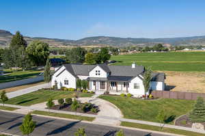 View of front of property with a front lawn and a mountain view