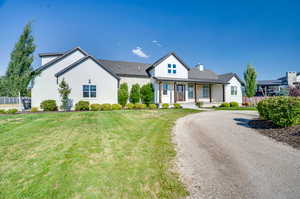 View of front of home with a porch and a front lawn