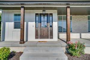 Doorway to property with covered porch