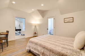 Bedroom featuring vaulted ceiling and light wood-type flooring