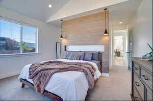 Bedroom featuring lofted ceiling and light colored carpet