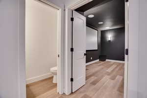 Bathroom with wood-type flooring and toilet