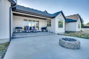 Back of property with a patio area and an outdoor fire pit