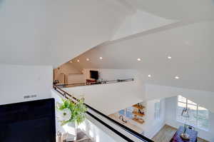 Interior space with wood-type flooring and beam ceiling