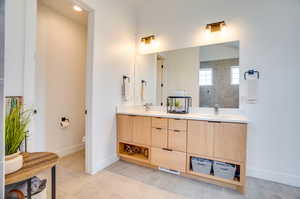 Bathroom featuring toilet, tile patterned flooring, and double vanity