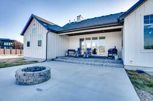 Rear view of house with a patio and a fire pit