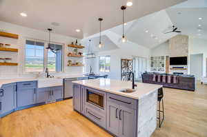 Kitchen featuring sink, appliances with stainless steel finishes, light wood-type flooring, and ceiling fan