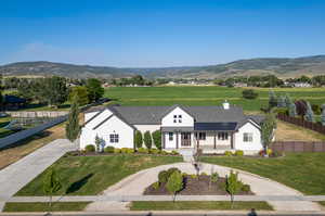 View of front facade with a mountain view and a front yard