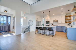 Kitchen featuring plenty of natural light, white cabinetry, pendant lighting, and stainless steel appliances