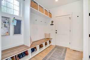 Mudroom with light hardwood / wood-style floors