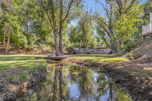 Creek/Gully, basketball court, archery range, on the lower level of the property below the pool area.