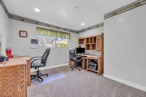 Home office/ 2nd bedroom featuring light colored carpet