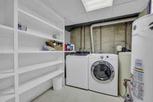 Laundry area with washing machine and clothes dryer and gas water heater with 2 40 gal water heaters