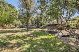 Creek/Gully, basketball court, archery range, on the lower level of the property below the pool area.