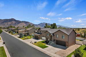 View of front of property featuring a garage and a mountain view