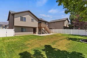 Rear view of property with a lawn