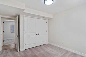 Unfurnished bedroom with a closet and carpet flooring