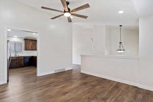 Unfurnished living room with lofted ceiling, ceiling fan, and dark hardwood / wood-style floors