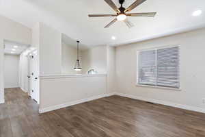 Empty room with wood-type flooring and ceiling fan