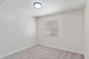 Unfurnished room featuring carpet