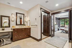 Bathroom featuring tile patterned flooring and vanity