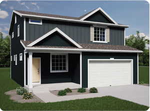 View of front of home with a garage and a front yard