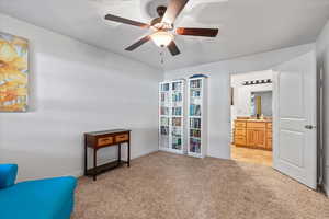 Sitting room with sink, ceiling fan, and light colored carpet