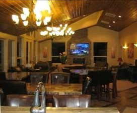 Dining room with vaulted ceiling, a chandelier, and wooden ceiling