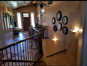 Entryway with vaulted ceiling and a chandelier