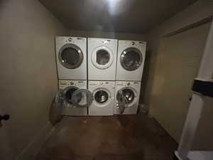 Laundry area with stacked washer and clothes dryer