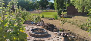 View of yard with a fire pit, facing south