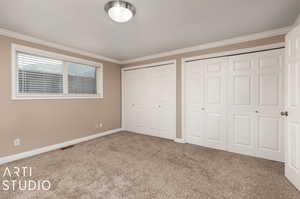 Unfurnished bedroom featuring carpet and ornamental molding