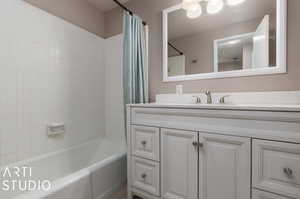 Bathroom with vanity and shower / bath combination with curtain