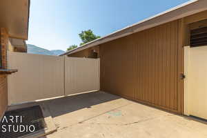 View of side of home with a mountain view and a patio area